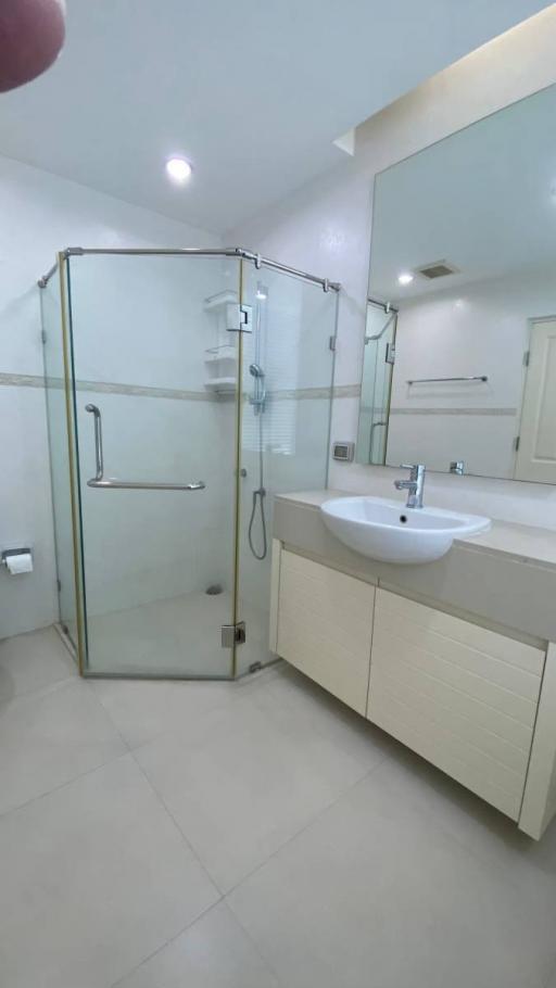 Modern bathroom with glass shower and white vanity