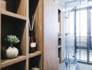 Modern bathroom interior with wooden shelving and glass shower