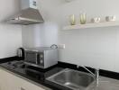 Modern kitchen with stainless steel appliances and white cabinetry