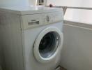 Siemens front-loading washing machine in a small laundry area