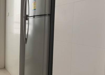 Modern stainless steel refrigerator in a bright kitchen