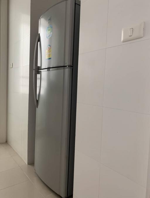 Modern stainless steel refrigerator in a bright kitchen