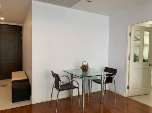 Minimalist dining area with glass table and modern chairs