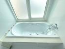 Spacious bathroom with a large jacuzzi and skylight