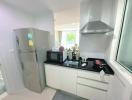 Modern kitchen with stainless steel appliances and white cabinetry