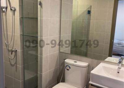 Modern bathroom with glass shower enclosure and white fixtures