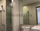 Modern bathroom interior with a shower, toilet, and tiled walls