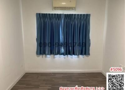 Empty bedroom with blue curtains and air conditioning unit