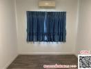 Empty bedroom with blue curtains and air conditioning unit