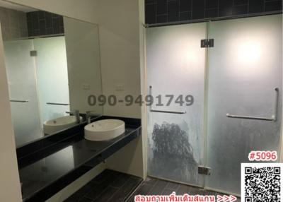 Modern bathroom with double vanity and glass shower