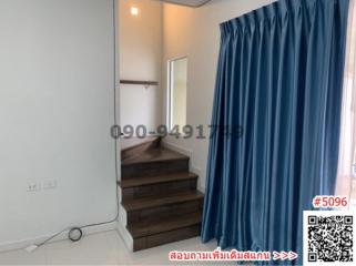 Bright bedroom with blue curtains and wooden steps leading to a platform