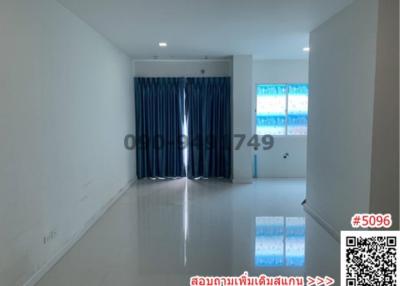 Spacious and bright empty living room with large windows and tiled floor