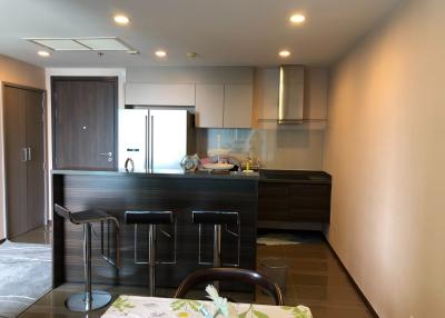 Modern kitchen with bar stools and dark wood cabinetry