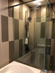 Modern bathroom with walk-in shower and beige tiles