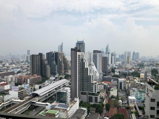 Expansive cityscape view from a high-rise building balcony showing numerous skyscrapers and buildings