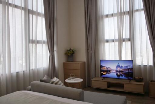 Cozy living room with natural light and modern television