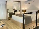 Spacious modern bedroom with large mirror and en-suite facilities