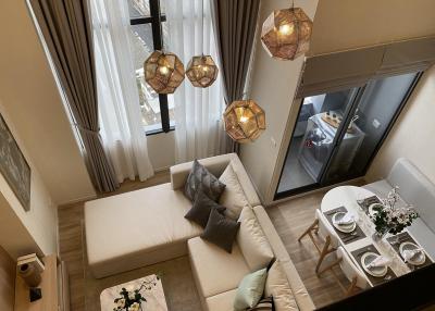 Modern living room with dining area and elegant lighting