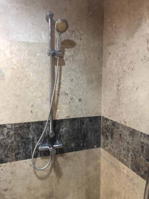 Modern bathroom shower system with stone wall tiles
