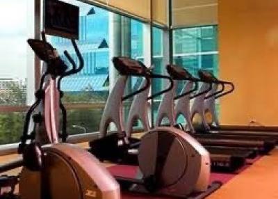 In-house gym with cardio equipment and city views