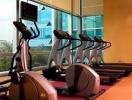 In-house gym with cardio equipment and city views