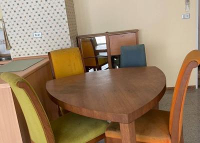 Round wooden dining table with chairs in a room
