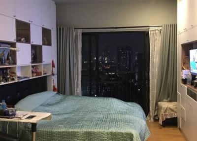 Cozy bedroom with city view at night