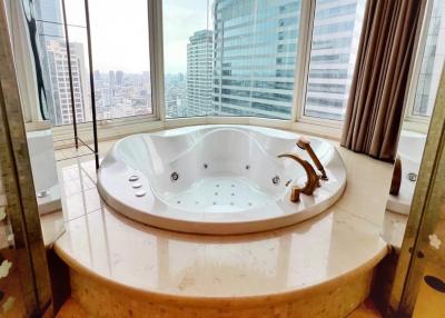 Spacious bathroom with a large jacuzzi tub and city view