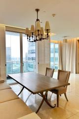 Elegant dining room with modern chandelier and city view