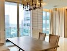 Elegant dining room with modern chandelier and city view