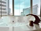 Luxurious bathroom with a large Jacuzzi tub and city view through floor-to-ceiling windows