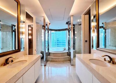 Luxurious bathroom with marble finishes and a city view