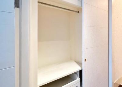 Modern built-in closet with open drawers and shelves