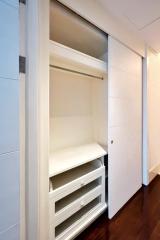 Modern built-in closet with open drawers and shelves