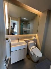 Modern bathroom with vanity, mirror, and toilet in a residential home