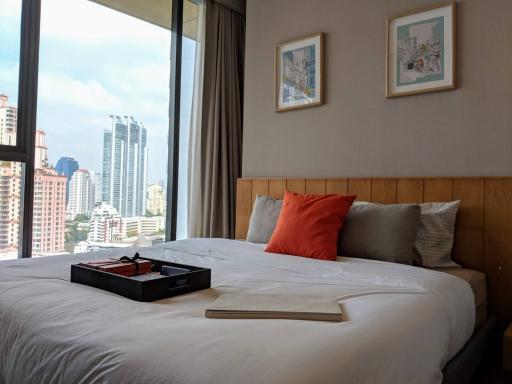 Modern bedroom with city view through large window