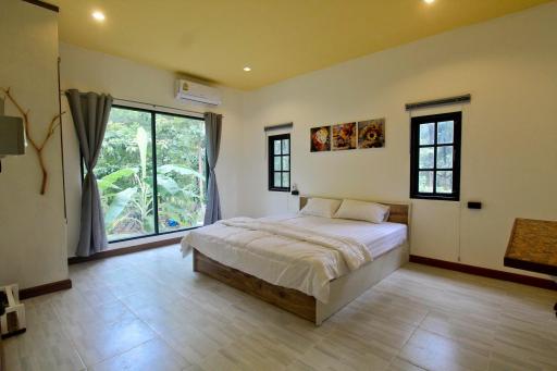 Spacious bedroom with modern furnishings and ample natural light