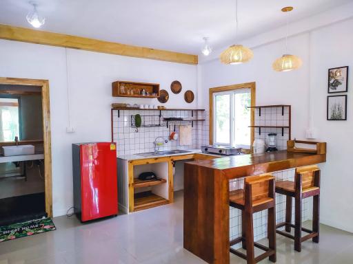 Modern kitchen with wooden accents and red refrigerator