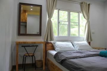 Cozy bedroom with natural light and a view of the outdoors