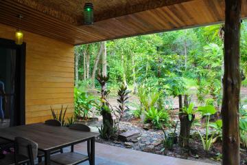 Cozy covered patio with a view of lush greenery