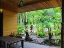 Cozy covered patio with a view of lush greenery