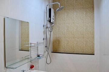 Modern bathroom shower with glass shelf and beige tiles