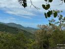 Panoramic mountain view with lush greenery under a clear blue sky