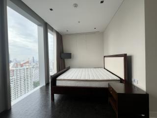 Spacious bedroom with a large window offering a city view