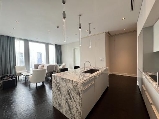 Modern kitchen interior with marble finishes and open-plan layout