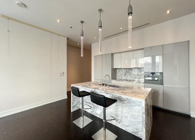 Modern kitchen with marble island and dark hardwood floors