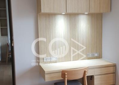 Modern bedroom interior with built-in wooden wardrobe and study desk