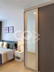 Cozy bedroom with modern sliding wardrobe and comfortable bedding