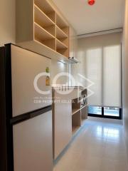 Compact modern kitchen with refrigerator and built-in shelves