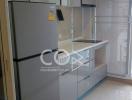 Modern kitchen with stainless steel refrigerator and minimalistic cabinets